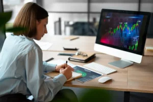 Person in the office analyzing and checking finance graphs