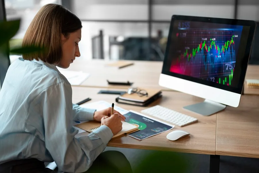 Person in the office analyzing and checking finance graphs