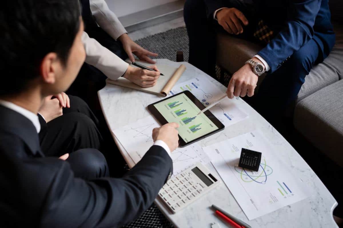 A group of professionals collaborates around a marble table
