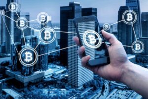 A person holding a smartphone with Bitcoin icons linked over a cityscape, symbolizing digital currency interaction.