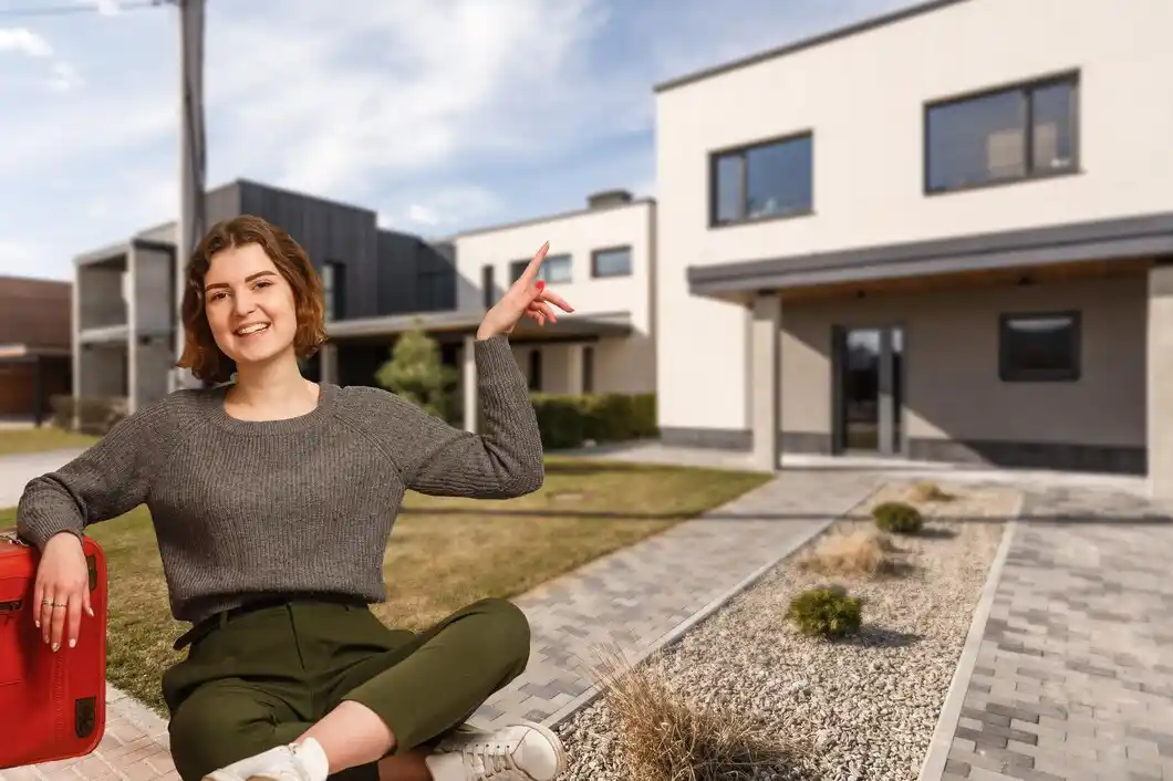 Happy woman on the background of a new house.