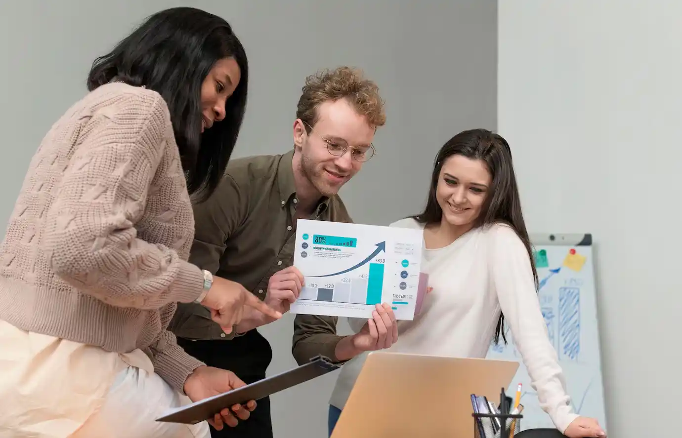 Group of young people teaming up at work