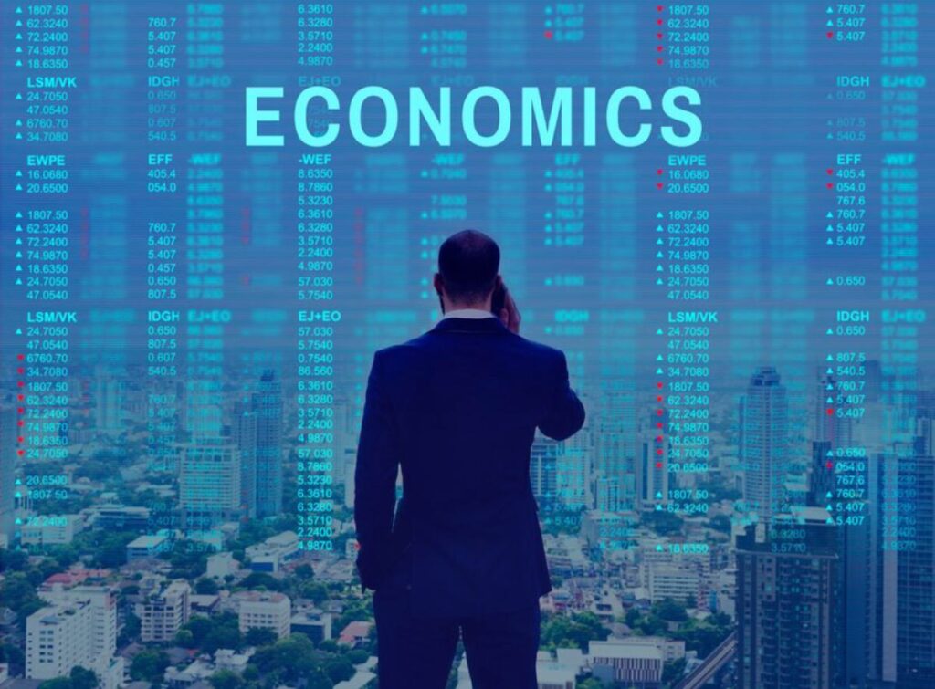 A businessman watches financial data projections overlaying a cityscape, symbolizing economic analysis and market insights.